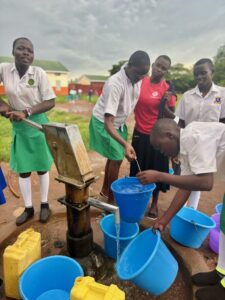 Girls with old water pump